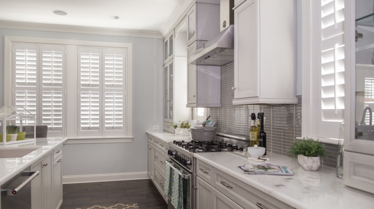 Plantation shutters in Orlando kitchen with modern appliances.